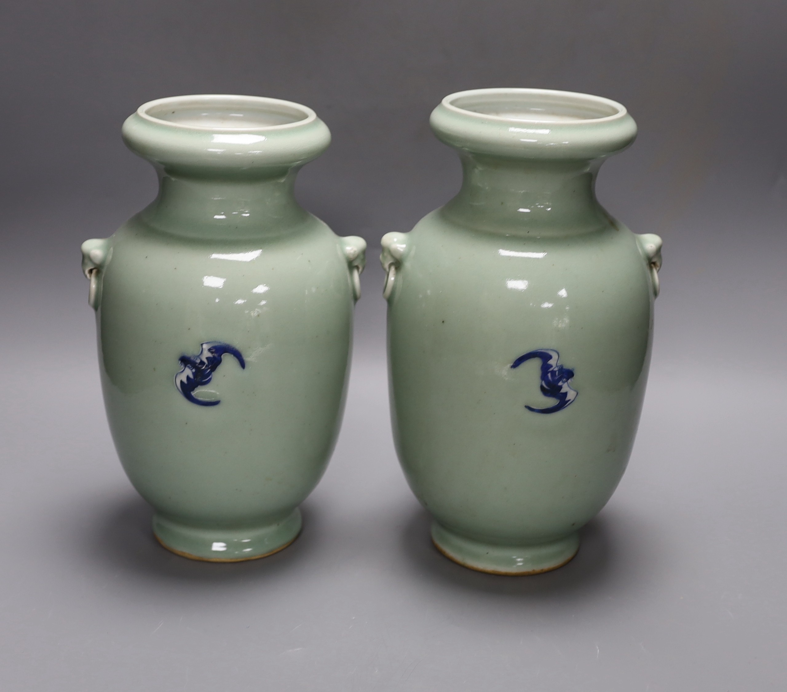 A pair of Chinese blue and white celadon ground vases, 26cms, painted with figures